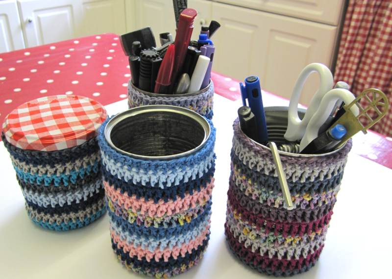 Crochet covers for tins and jars.