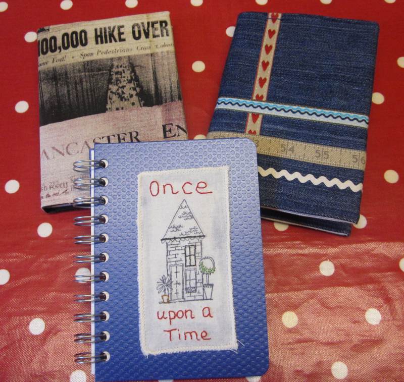 Three fabric covered books.